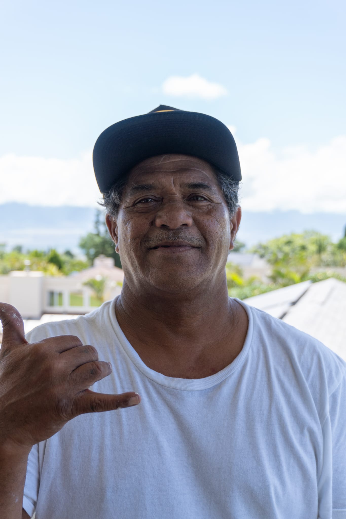 97 Painting Maui, Man in white t-shirt and black cap
